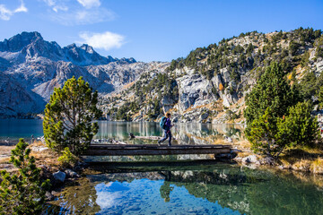 Young hiker woman in autumn in Aiguestortes and Sant Maurici National Park, Spain