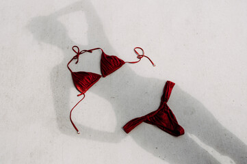 feminine silhouette in summer light and red swimsuit