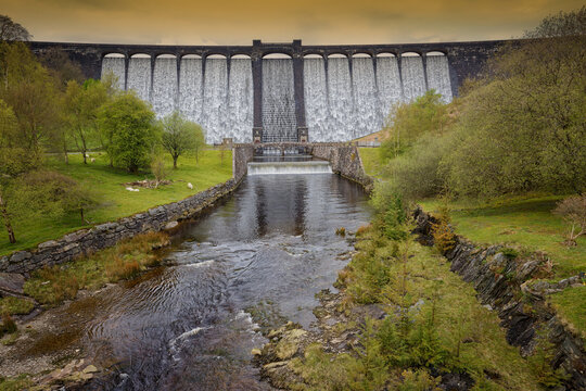 With the reservoir full the water overflows at the Caerwen Dam The Elan Valley Wales UK