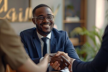 Man in formal attire smiles while shaking woman's hand