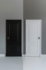Two doors side by side, one painted black and the other white, against a neutral gray background. The stark contrast between the doors creates a striking visual effect. 