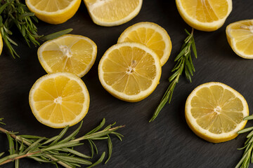 slices of sour lemon on a black board