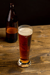 dark beer in a glass glass, fresh dark alcoholic beer