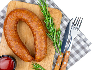 Smoked sausage on a cutting board with spices top view processed meat