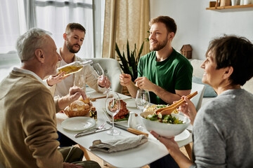 A gay couple shares a meal with parents at home.
