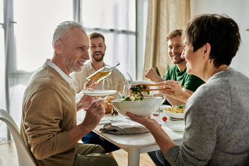 A gay couple enjoys dinner with parents at home.