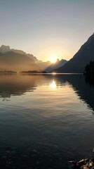 Sunrise reflecting over mountain lake