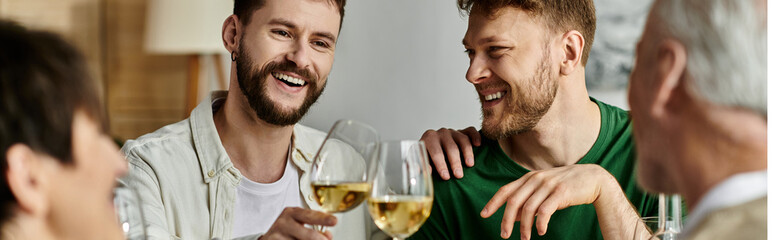 Fototapeta premium A gay couple enjoys a drink with parents at home.