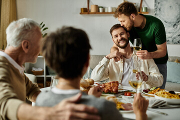 A gay couple enjoys dinner with parents, with one partner receiving a loving kiss on the head.