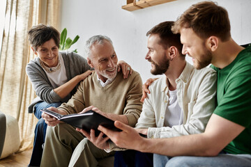 A gay couple shares a photo album with parents, creating a loving and heartwarming family moment.