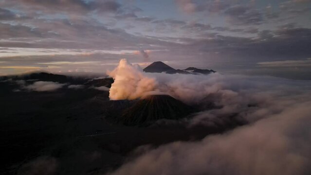 Landscape view of misty mount Bromo volcano. Foggy morning in the java national park with mount Semeru