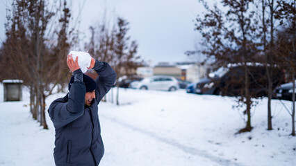 A young man throwing a snowball