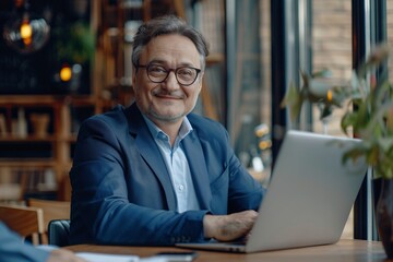 Confident Middle-Aged Businessman Working on Laptop in Office, Smiling at Camera - 8k Real Photo