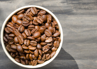 Coffee beans on a black background. Roasted coffee beans are ready for grinding.