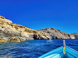 Magraner cove. Old basalt quarry and sunken excavator. Mediterranean coastline. Amazing clear blue...