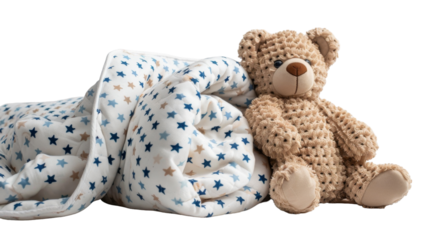 A plush bear toy sits next to a soft blanket with blue star print