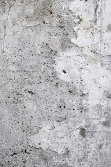 Obraz premium Close-up of a worn concrete wall with cracks and stains, showcasing texture and age. Great for backgrounds or as an example of urban decay.