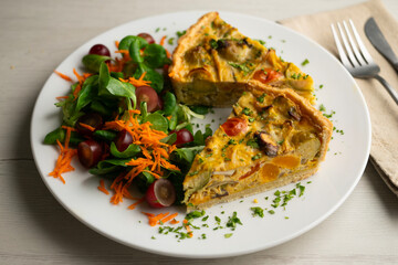 French quiche with fall vegetables such as brussels sprouts, sweet potato, and mushrooms.