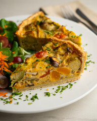 French quiche with fall vegetables such as brussels sprouts, sweet potato, and mushrooms.