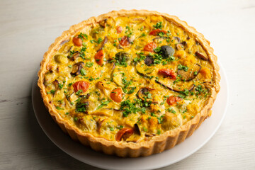 French quiche with fall vegetables such as brussels sprouts, sweet potato, and mushrooms.