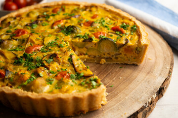 French quiche with fall vegetables such as brussels sprouts, sweet potato, and mushrooms.