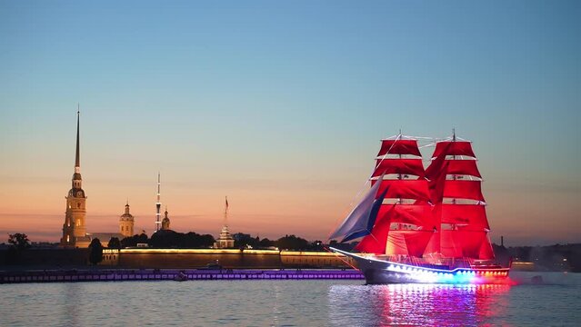 A sailboat with Scarlet Sails sails on the Neva. Miracle brig on the Neva River in St. Petersburg, romantic ship with scarlet sails. White nights