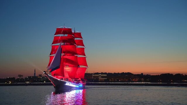 A sailboat with Scarlet Sails sails on the Neva. Miracle brig on the Neva River in St. Petersburg, romantic ship with scarlet sails. White nights