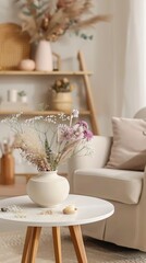 a vase with pastel flowers on a white side table near an armchair in a living room, shown in a closeup view.