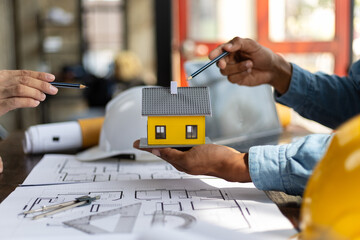 Colleague male architects in office discussing construction project. Young man working together on...