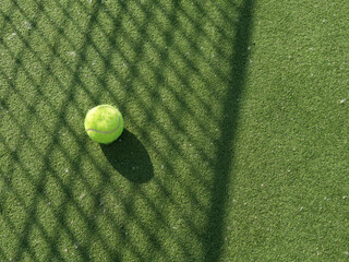  tennis ball back light shadow on tennis grass court good for background