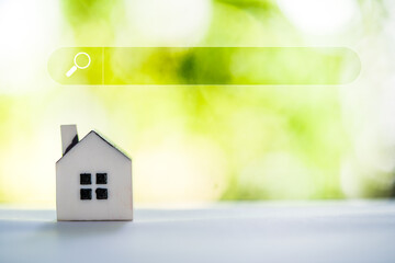 Search engine optimization concept. Empty search bar and model home, search for find information data about home. Search advertising for rent or buy a home. Choosing right house