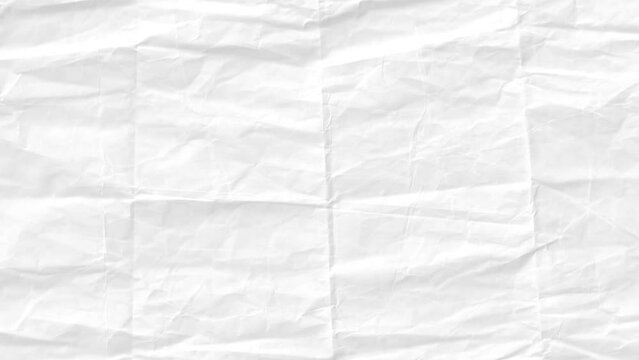 A close-up of crumpled white paper with a rough, wrinkled texture and creases