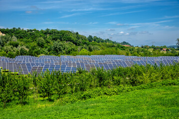 Solar panel park installed in vegetation in the hills in Piedmont, Italy © framarzo