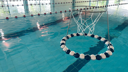 Obraz premium Equipment for water sports and training. A ring for playing water soccer on the surface of the water in the swimming pool. Equipment for water sports and training.