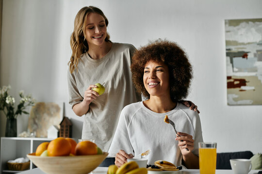 A lesbian couple enjoys a casual morning together at home.