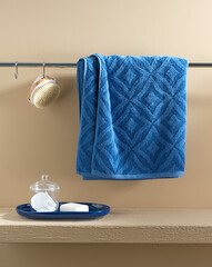 blue towels on the bathroom shelf