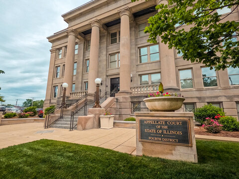 Appellate Courthouse of the State of Illinois Fourth District Front Facade in Springfield, Illinois, USA. Cloudy blue skies overhead. Side profile view.
