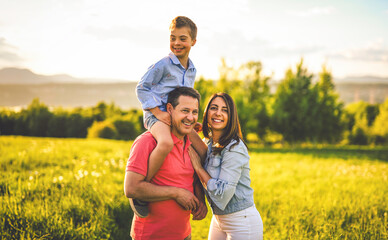 Fototapeta premium Nice family Playing on great field at Sunset