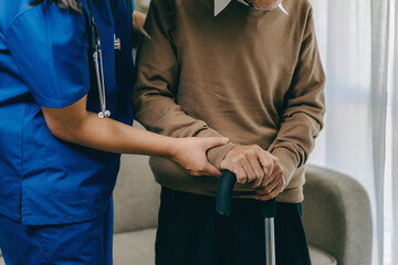 Nurse holding a senior patients 's hand on a walking stick. special medical care concept for...