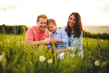 Fototapeta premium Nice family Playing on great field at Sunset