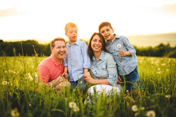 Fototapeta premium Nice family Playing on great field at Sunset