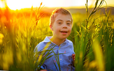 Portrait of a little boy having fun at the sunset time