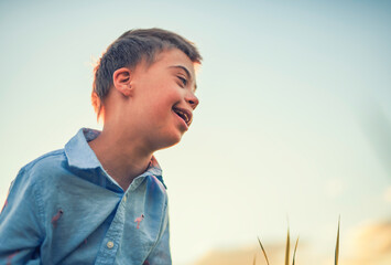 Portrait of a little boy having fun at the sunset time