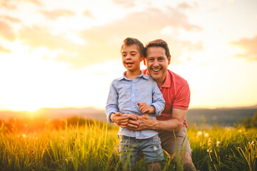 Nice father and child Playing on great field at Sunset