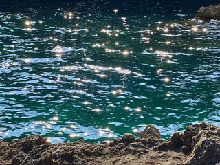 Glittering sea water blue turquoise sparkling water of Mediterranean coast