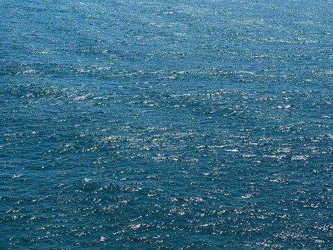 Blue water surface, calm sea shiny aqua.