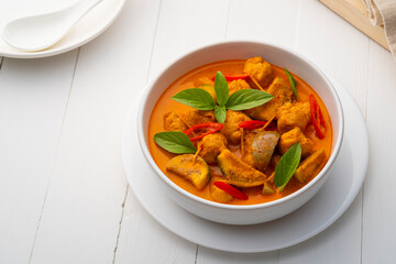 Red curry with clown featherback fishball in white bowl (Gaeng Kua Look Chin pla)