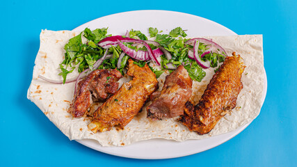 Lamb and chicken kebab on plate top view