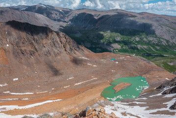 Aerial top view to glacier of unusual color and most beautiful turquoise glacial lake with stony...