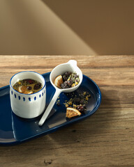 herbal hot tea with cups on the shelf